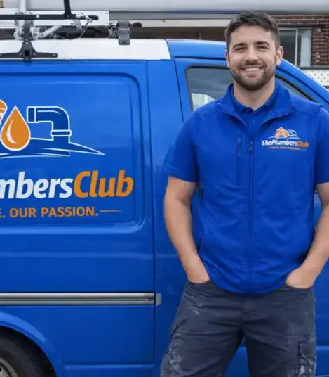 Plumber standing next to his van image